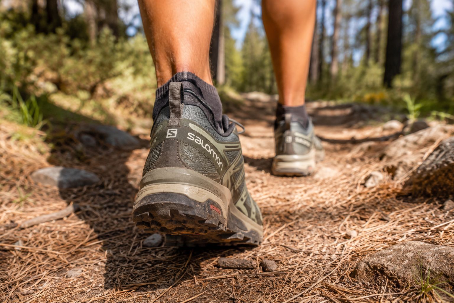 hiker's feet wearing Salomon trail shoes,
